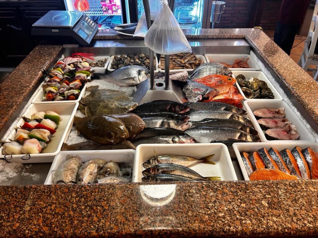 Étal de poissonnerie : poissons entiers et fruits de mer sur glace